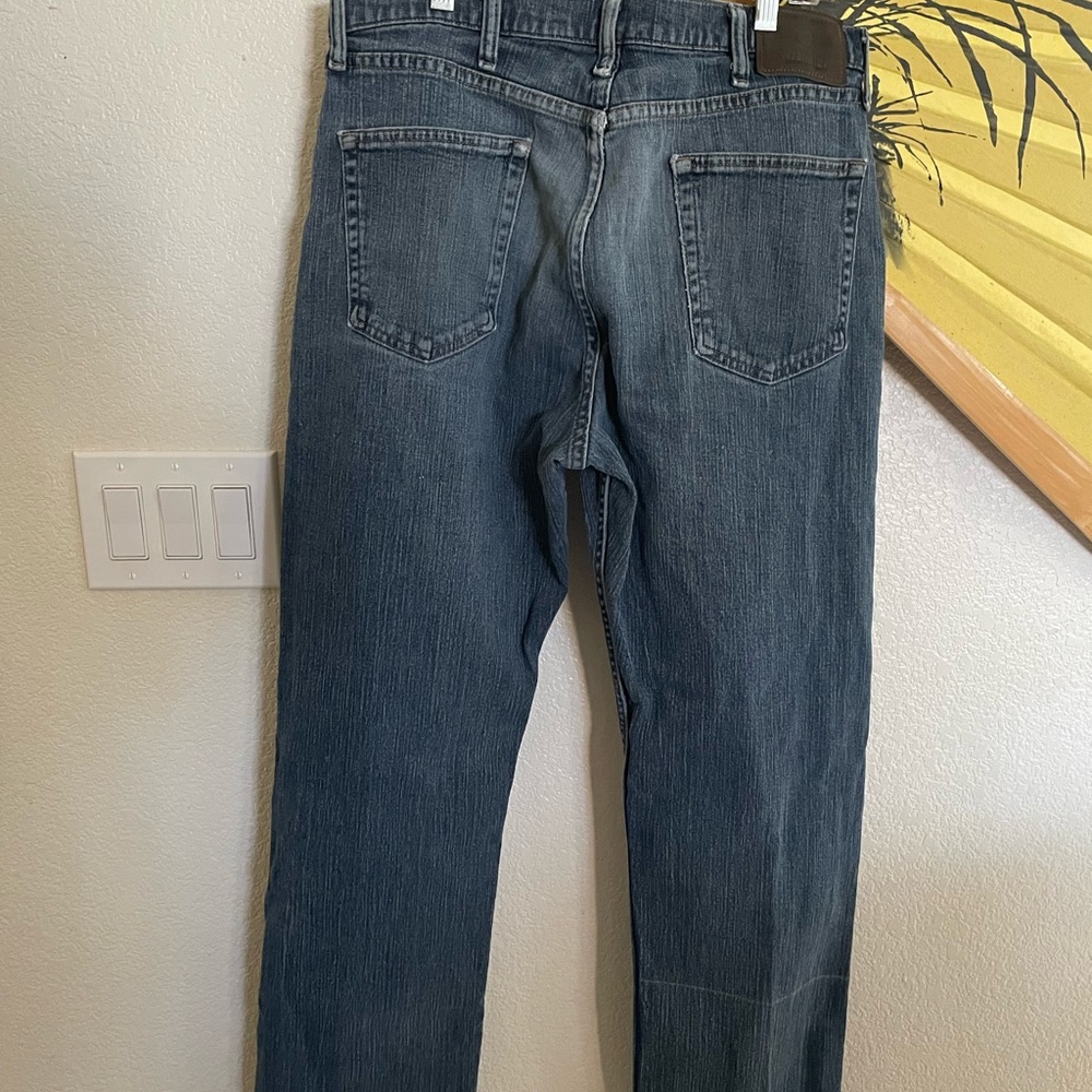 Men’s distressed Wrangler Jeans size 34x32, medium wash denim.